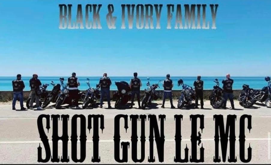 Shot Gun MC Italian chapter lined up with their motorcycles on the coast